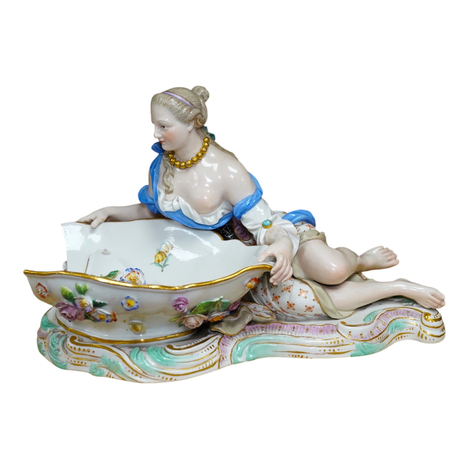 A Meissen female figural dish, 27cm wide. Condition - dish damaged (pieces in bag), crack near front knee